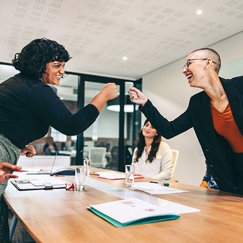 Two employee doing a fist bump